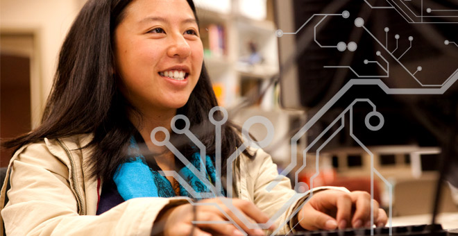Cyber Challenge student at table on computer