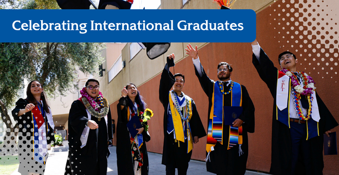 six students in graduation gowns throwing their caps in the air