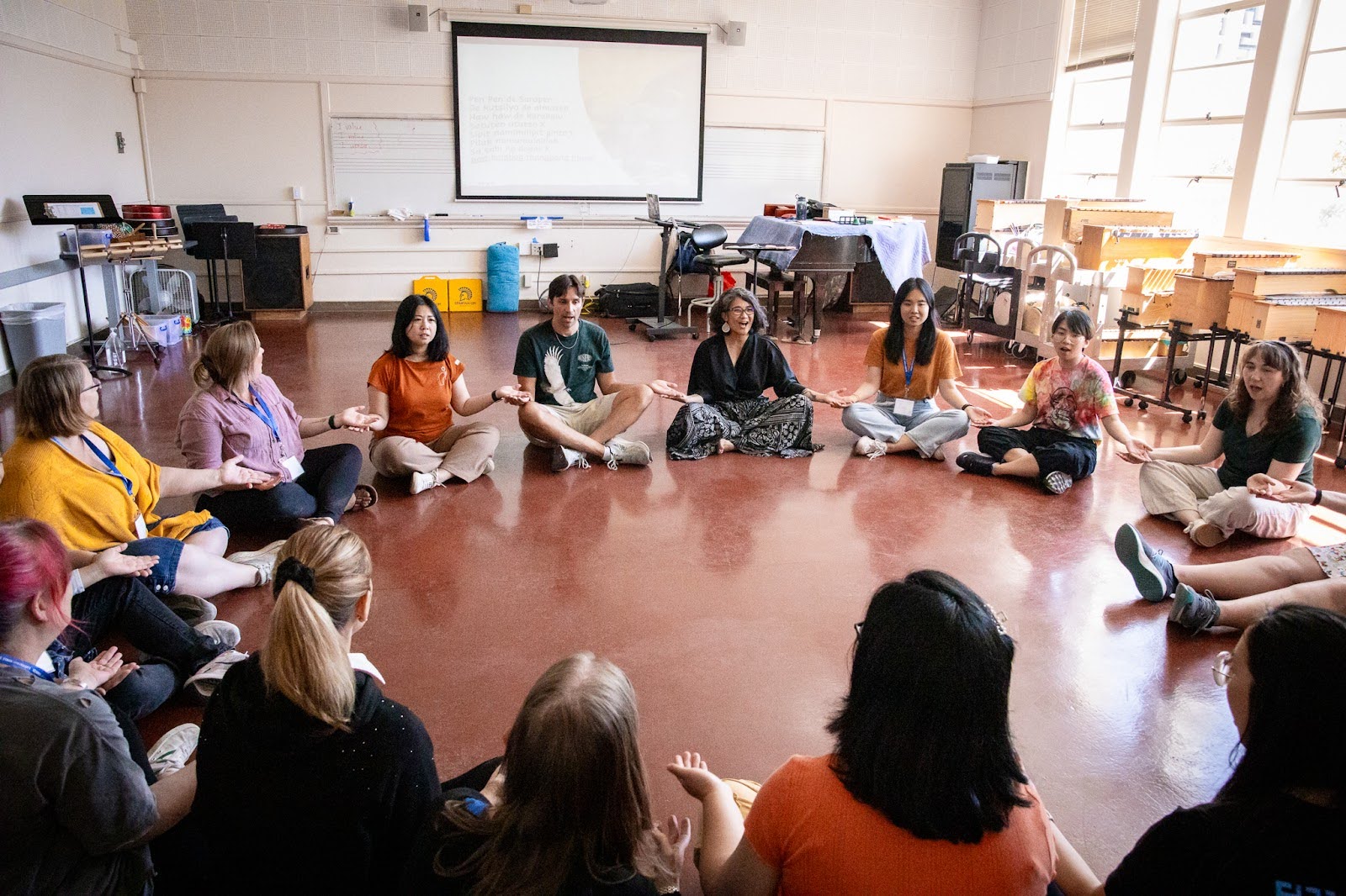 Orff instructer and students sitting together