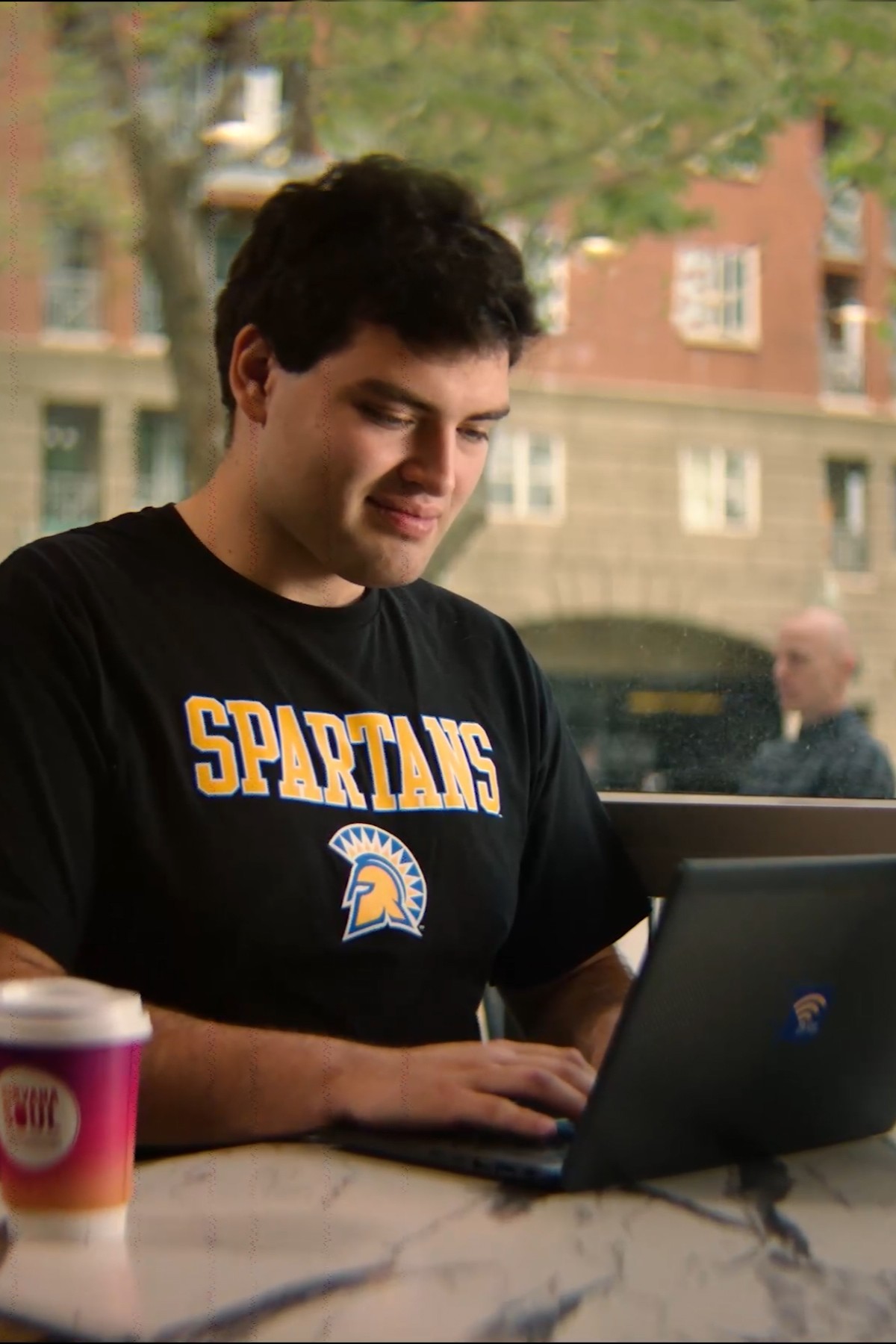SJSU Online student using campus resources on a laptop